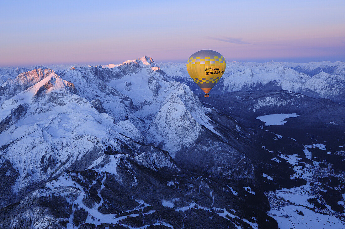 Aerial view of hot-air balloon flying above Alpspitze, Jubilaeumsgrat, Zugspitze, lake Eibsee and Garmisch, Garmisch-Partenkirchen, Wetterstein range, Bavarian alps, Upper Bavaria, Bavaria, Germany, Europe