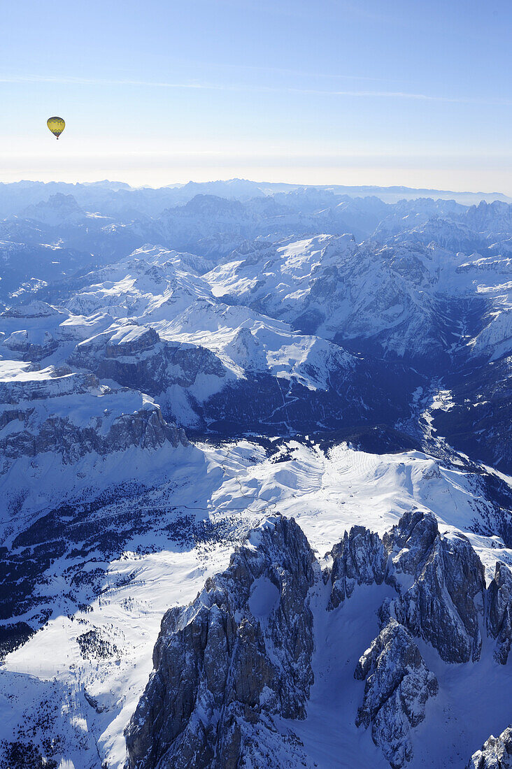 Hot-air balloon flying above Dolomites with Langkofel and Plattkofel in foreground, Sella range, Marmolada range and Pala range in background, aerial photo, Dolomites, South Tyrol, Italy, Europe
