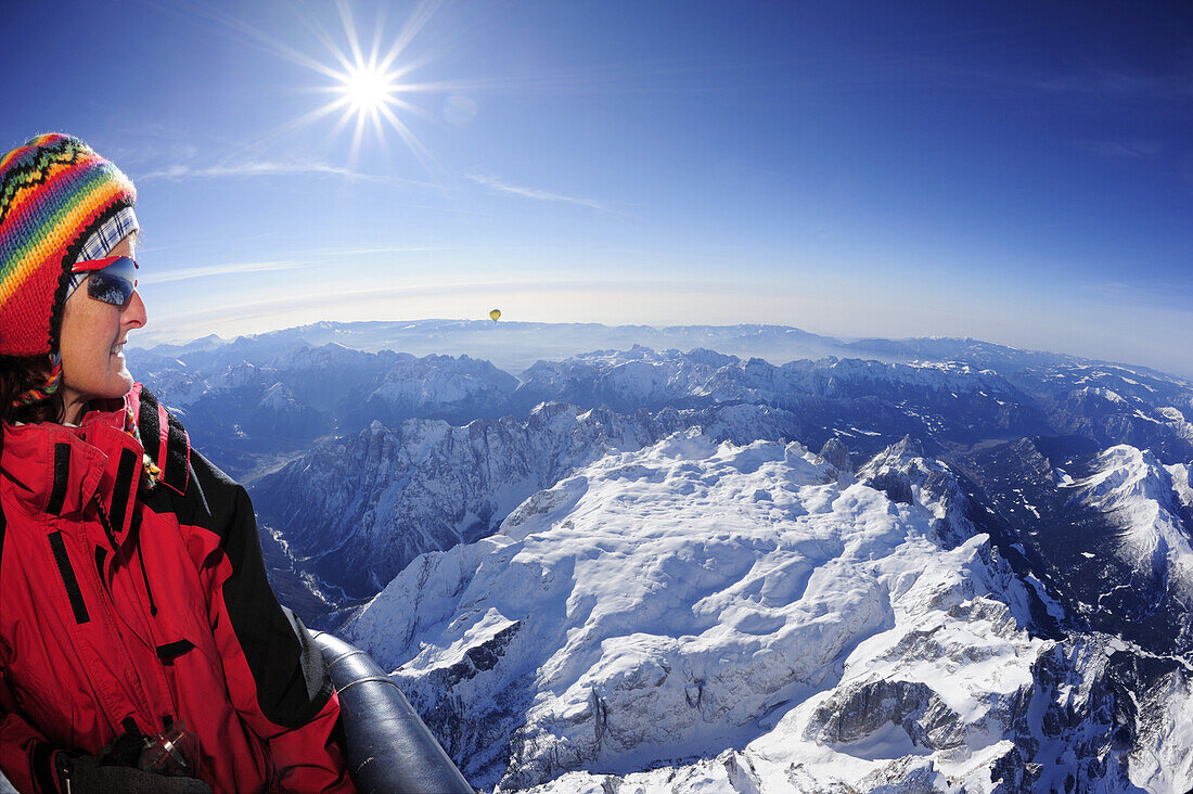 Woman in hot-air balloon enjoying view to Pala range in winter, aerial photo, Pala range, Dolomites, Venetia, Italy, Europe