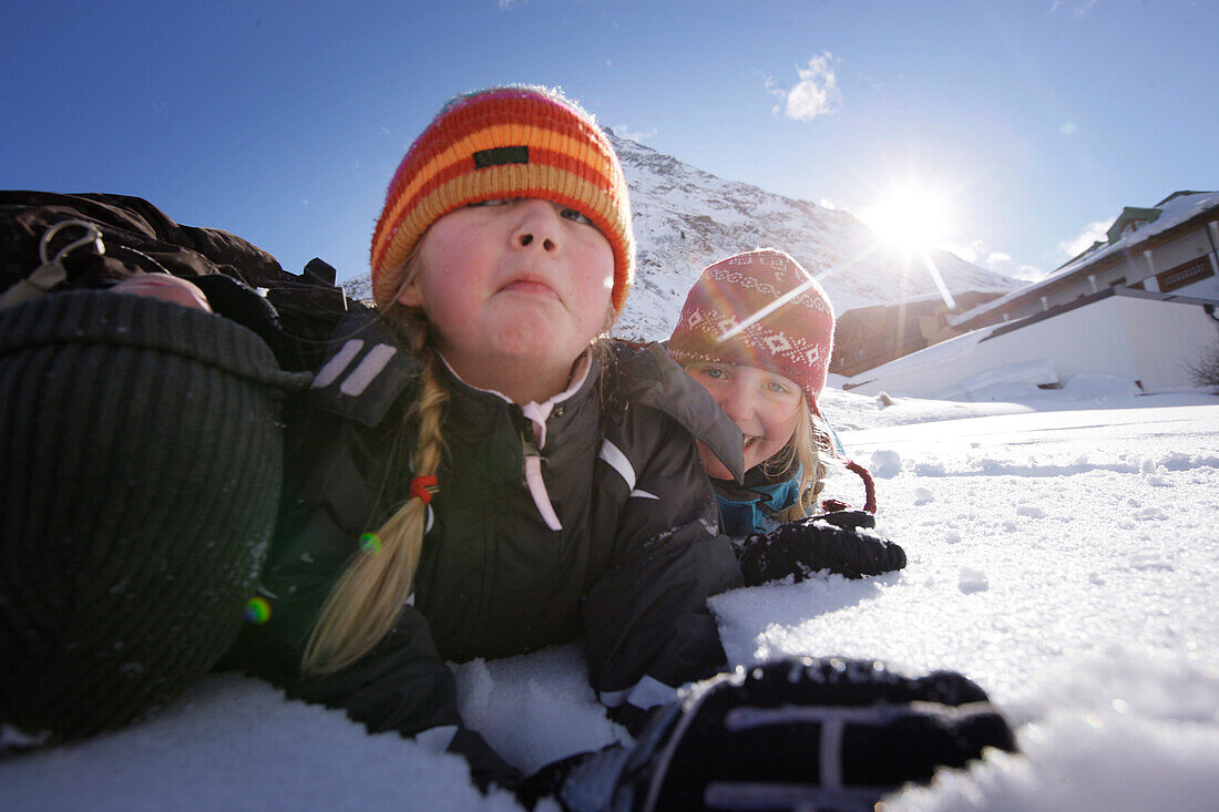 Children playing in snow, Galtuer, Paznaun valley, Tyrol, Austria
