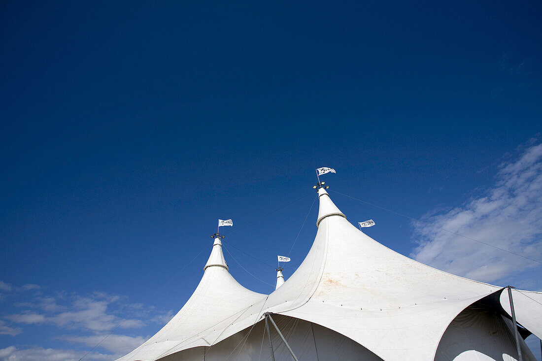 Blue, Blue sky, Circus, Color, Colour, Concept, Concepts, Daytime, Entertainment, exterior, From below, Low angle, Low angle view, Marquee, Marquees, outdoor, outdoors, outside, Skies, Sky, Tent, Tents, View from below, Viewed from below, Views from below