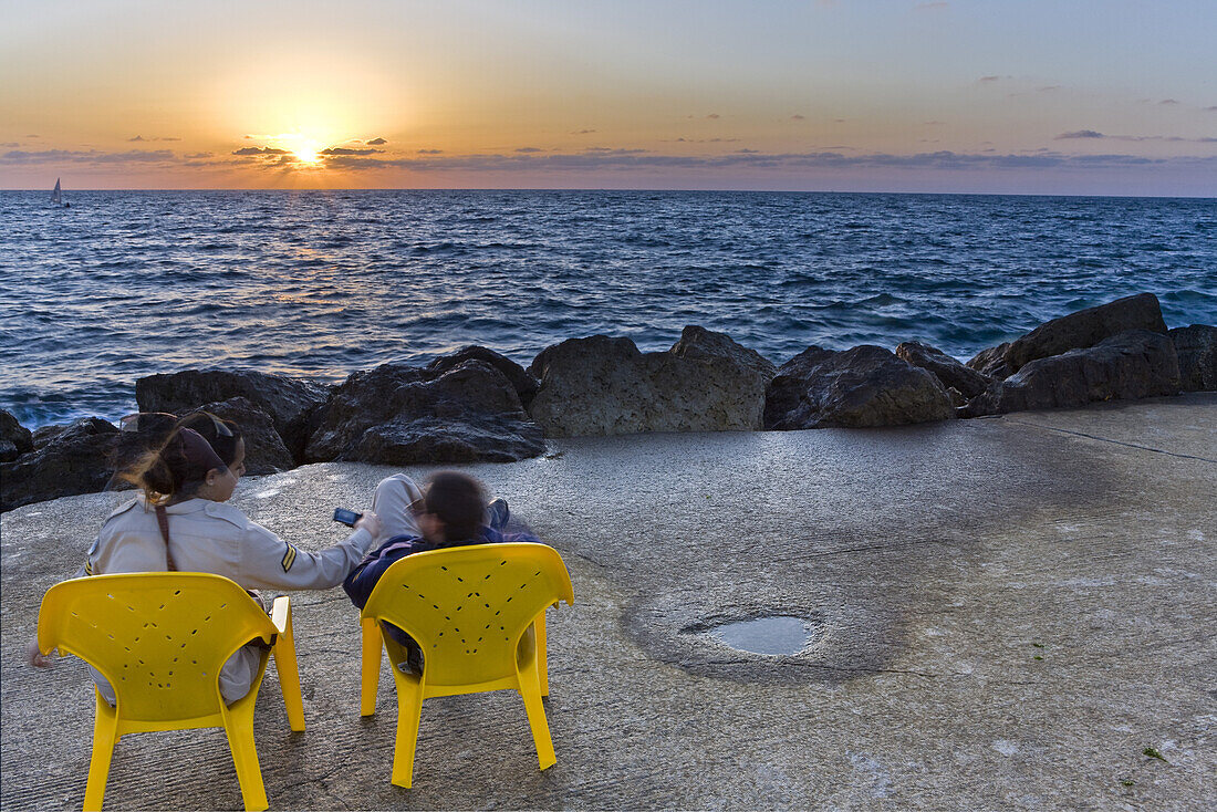 Couple enjoying the sunset over the mediterranean sea, Tel Aviv, Israel, Middle East