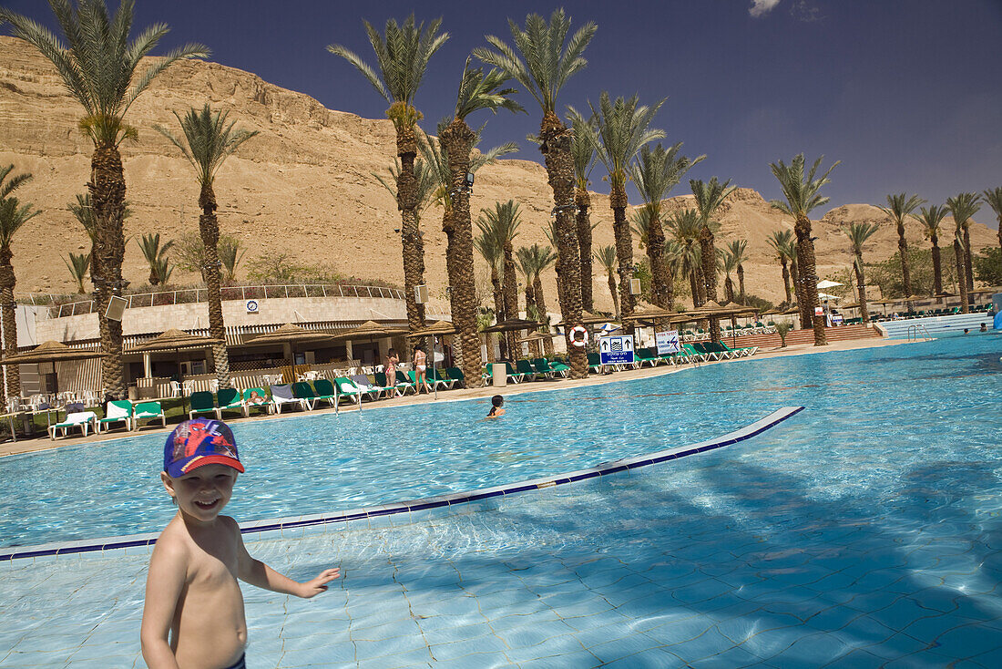 Boy in the swimming pool of the Meridean Hotel resort, En Bokek, Israel, Middle East