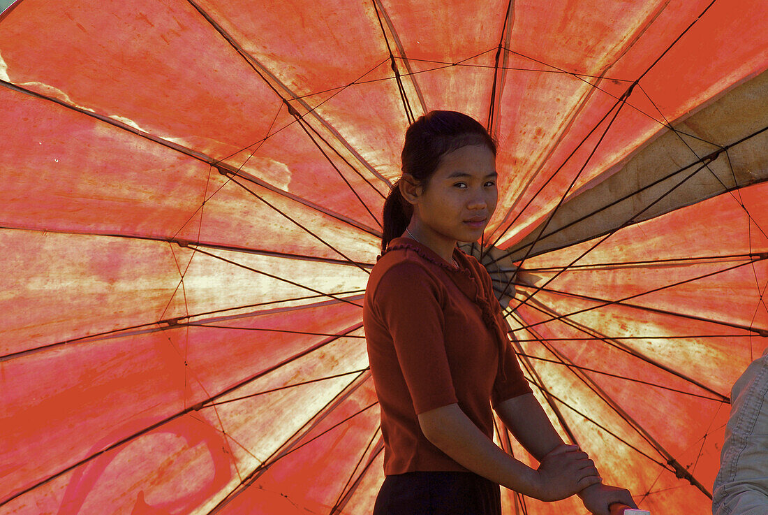 Asian woman with market umbrella, South Laos, Laos, Asia