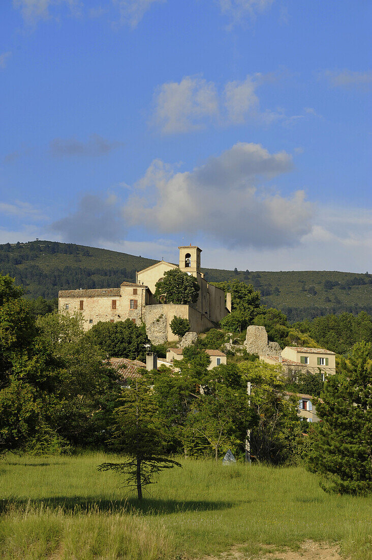 Village of Saint Jurs in front of the mountains of the Haute Provence in the sun on the plateau of Valensole, Provence, France, Europe