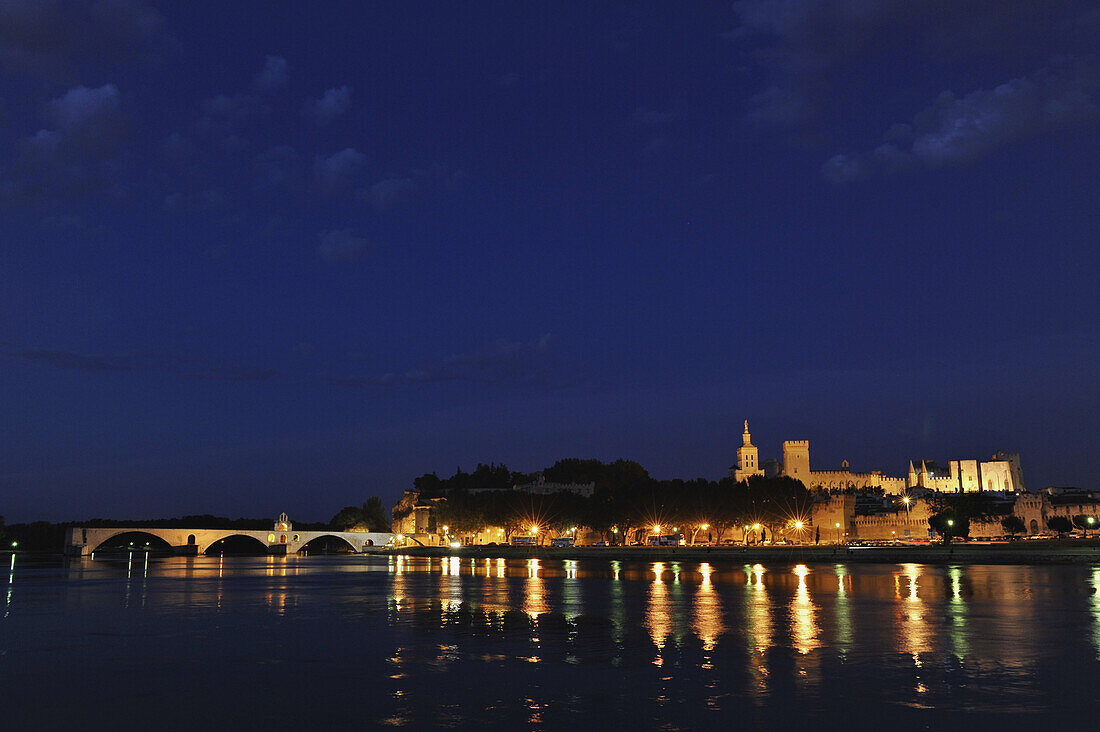 View over river Rhone to the bridge, city walls, cathedral Notre-Dame-des-Doms and papal palace at night, Avignon, Vaucluse, Provence, France, Europe