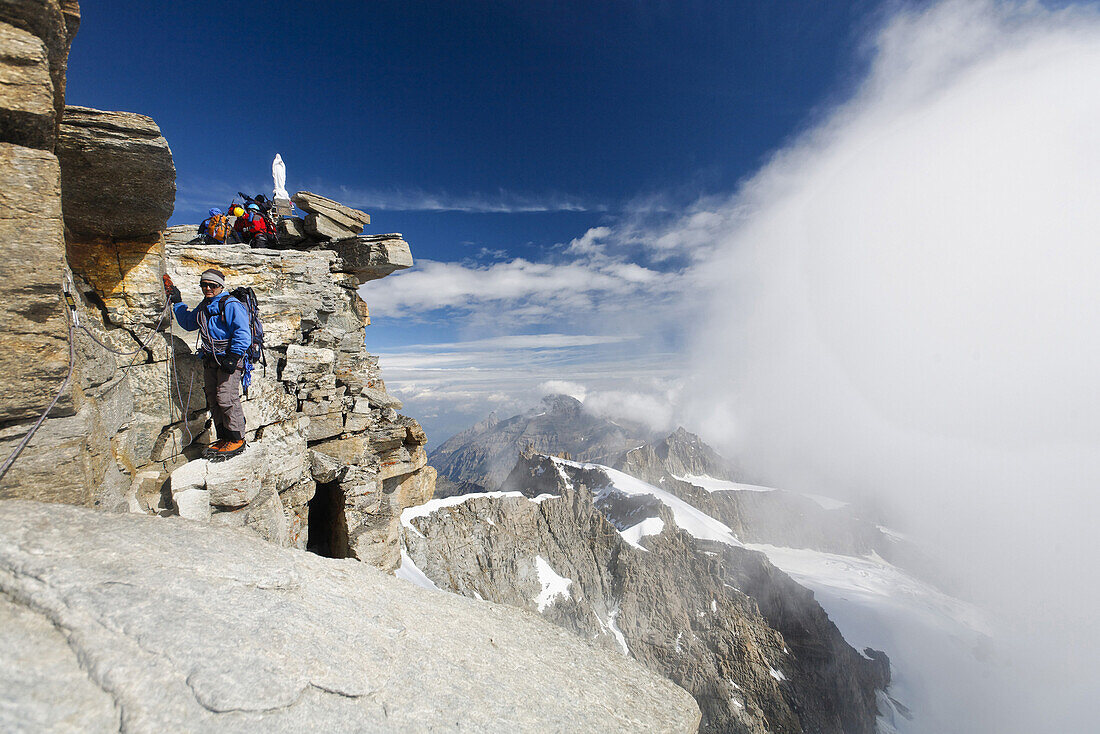 Mountaineer reaching summit of Gran Paradiso, Gran Paradiso National Park, Aosta Valley, Italy
