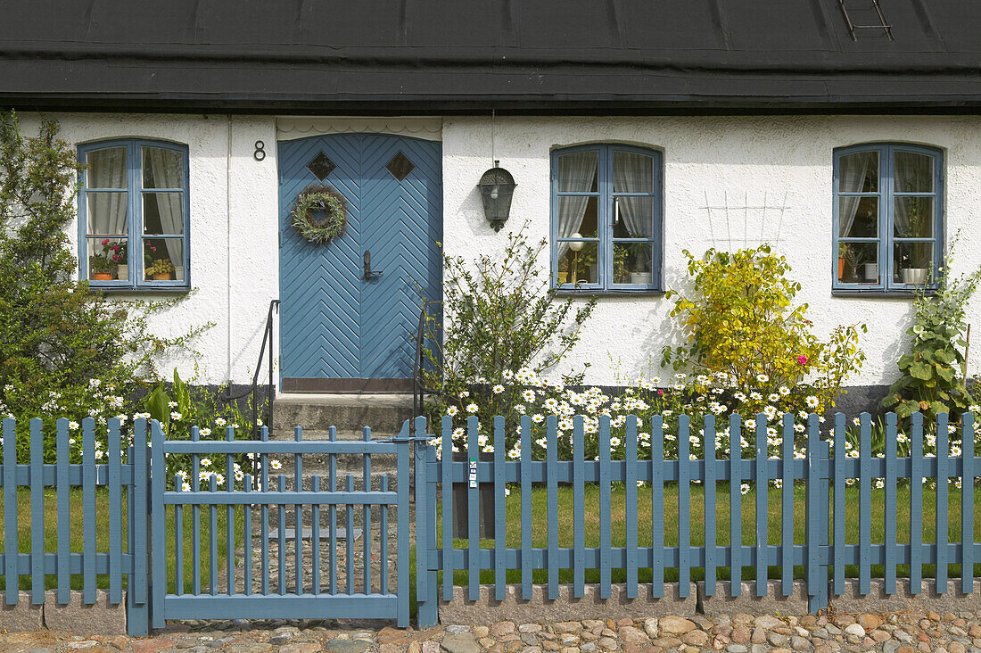 Blue gate in front of old house
