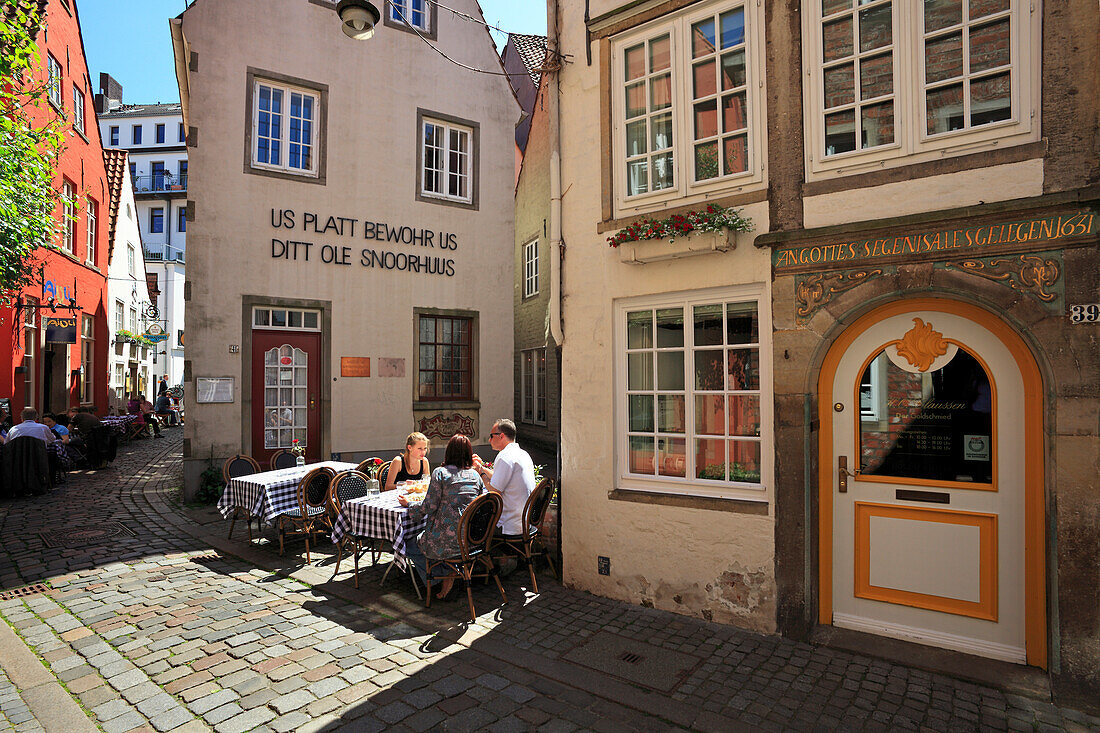 People at street cafe and historical houses at Schnoor quarter, Hanseatic City of Bremen, Germany, Europe