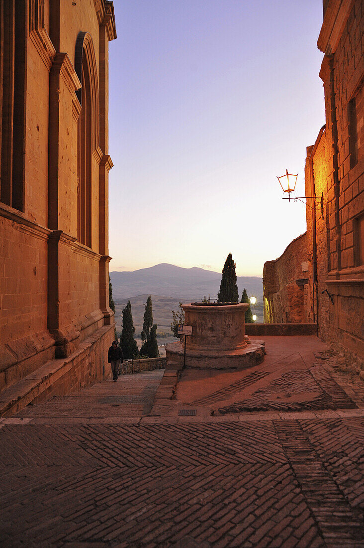 View through Duomo and house to Monte Amiata in the evening, Pienza, Tuscany, Italy, Europe