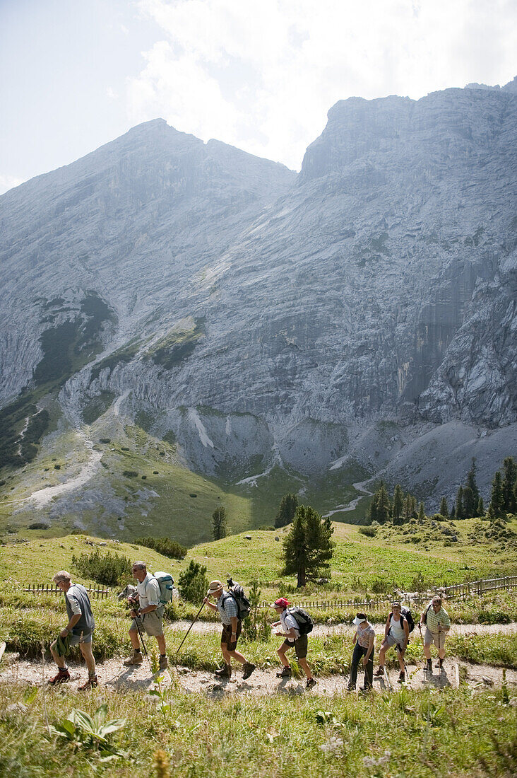 Hikers ascending mount Schachen, Wetterstein range, Upper Bavaria, Germany