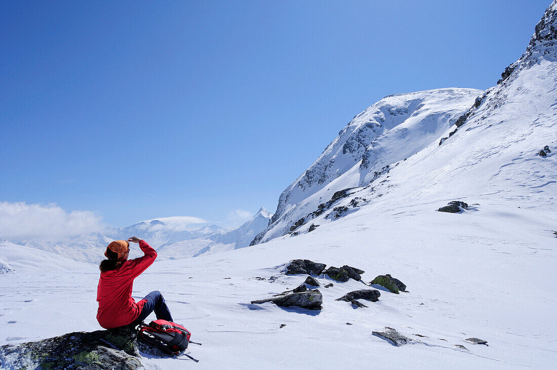Female backcountry skier resting, Rauris valley, Goldberg mountain range, Hohe Tauern, Salzburg, Austria