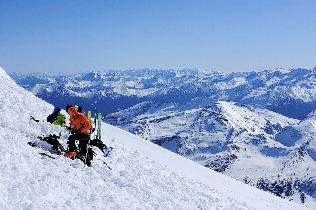 Backcountry skiers having a break at the summit, Hocharn, Rauriser Tal valley, Goldberggruppe mountain range, Hohe Tauern mountain range, Salzburg, Austria