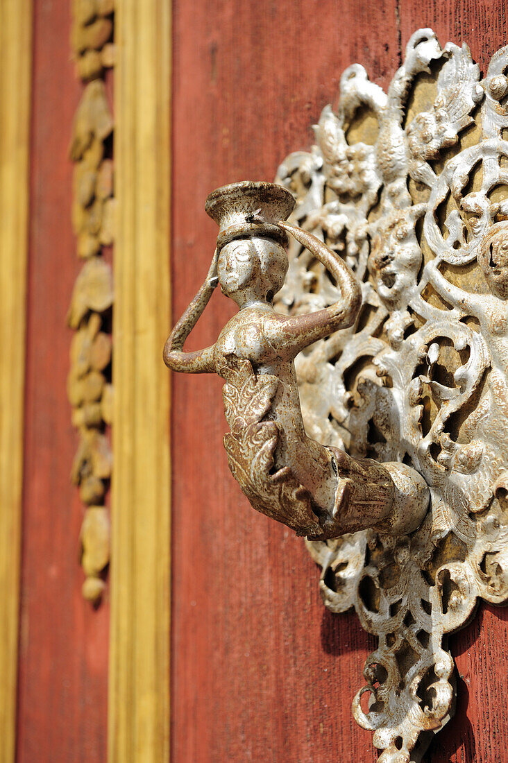 Figure as a doorknob on the church door, St. Georg, Dinkelbuehl, Bavaria, Germany