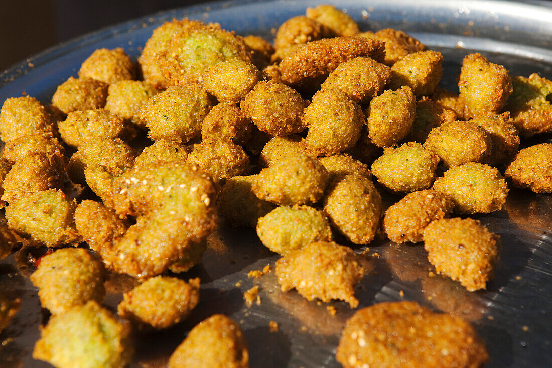 Fried zucchini balls displayed at a food stand in the zouk, Abu Simbel, Egypt, Africa