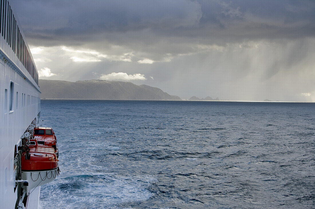 Cruiseship MS Deutschland and Cape Horn coastline under clouded sky, Isla Hornos, Magallanes y de la Antartica Chilena, Patagonia, Chile, South America, America