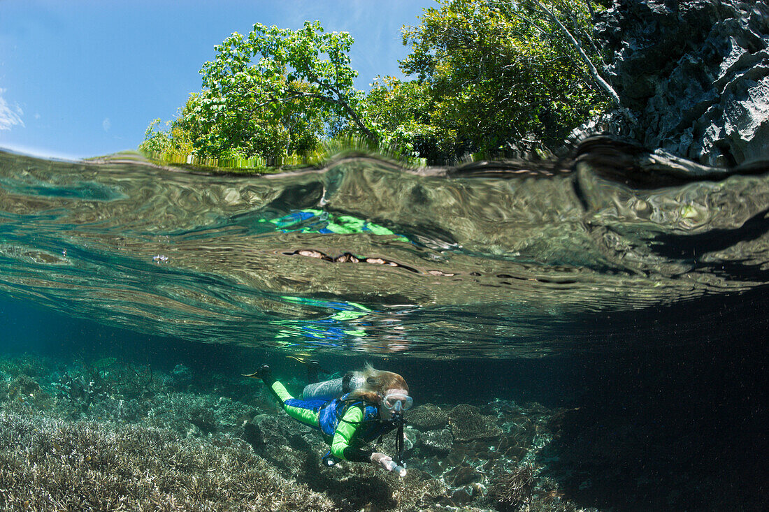 Snorkeling at shallow Coral Reef, Raja Ampat, West Papua, Indonesia