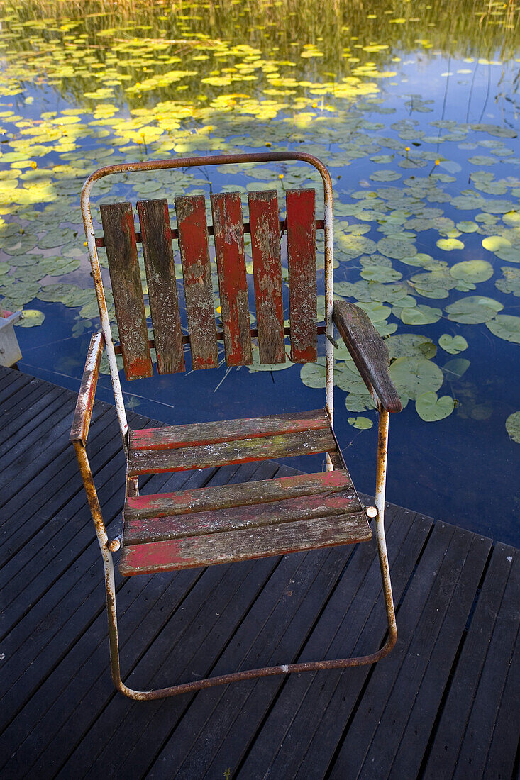 Weathered garden chair on a jetty