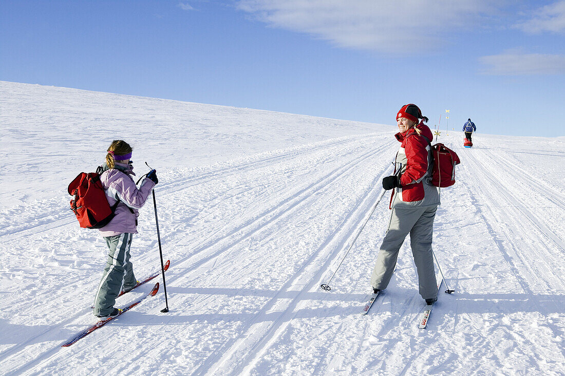 Woman and girl are skiing