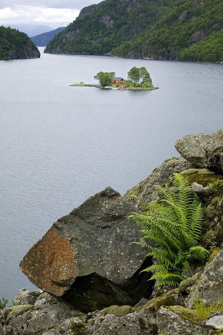 Small red cottage on a tiny island, Norway