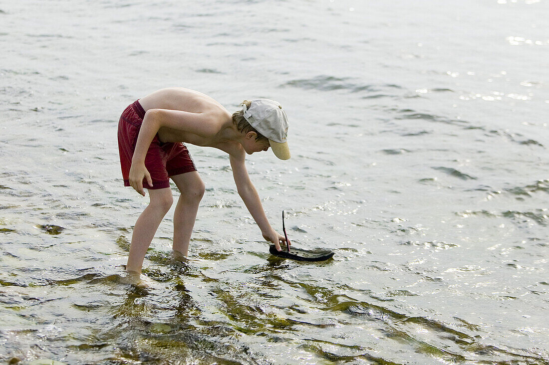 Boy playing with boat (MR)