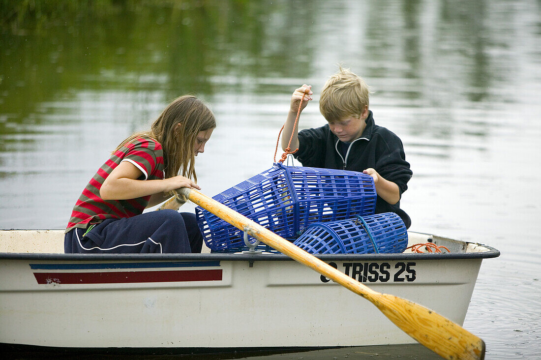 Boy and girl fishing for crayfish (MR)