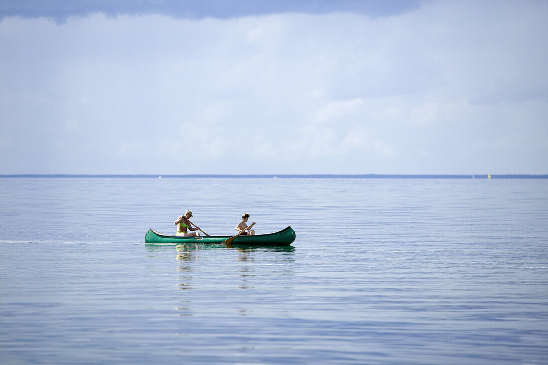 Mother and son paddling a canoe