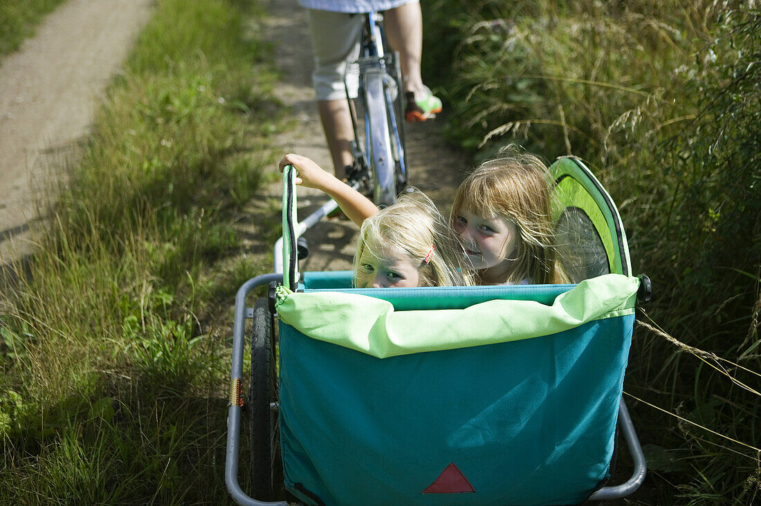 Two girls in bike cart