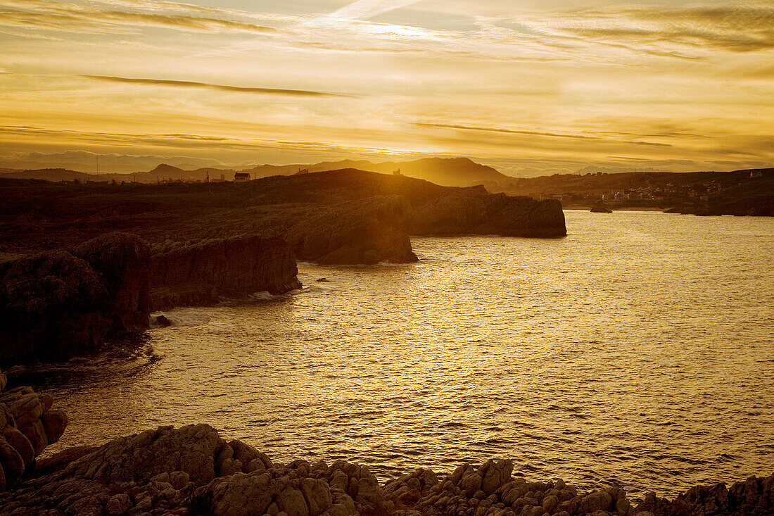 Cliffs and Virgen del Mar beach at sunset, Bay of Biscay, Santander, Cantabria, Spain