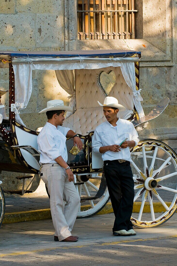 Calandrias horse drawn carriages and their drivers, on Avenida Corona in the historic Center of Guadalajara, Jalisco, Mexico