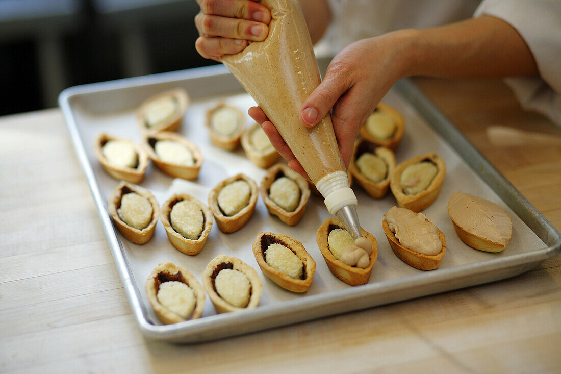 Pastry chef making small pastries