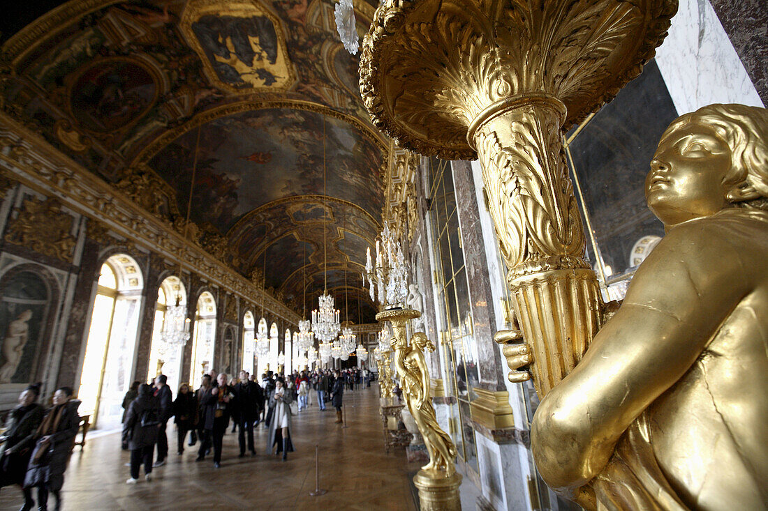 Beautifully guilded lamps decorating the Hall of Mirrors in Chateau of Versailles, Paris. France