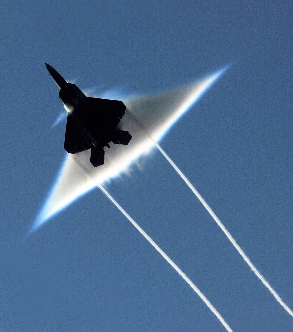 090622-N-7780S-014 GULF OF ALASKA June 22, 2009 An Air Force F-22 Raptor executes a supersonic flyby over the flight deck of the aircraft carrier USS John C  Stennis CVN 74  John C  Stennis is participating in Northern Edge 2009, a joint exercise focusing