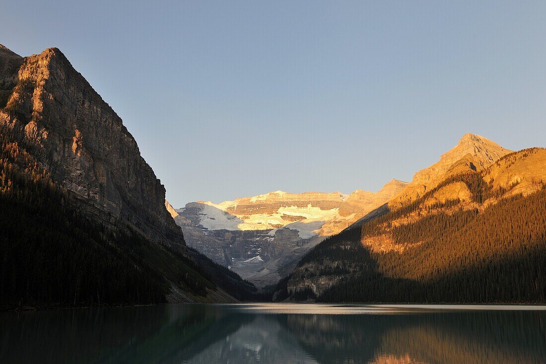 Sunrise and moutains reflecting in Lake Louise, Banff National Park, Rocky Mountains, Alberta, Canada