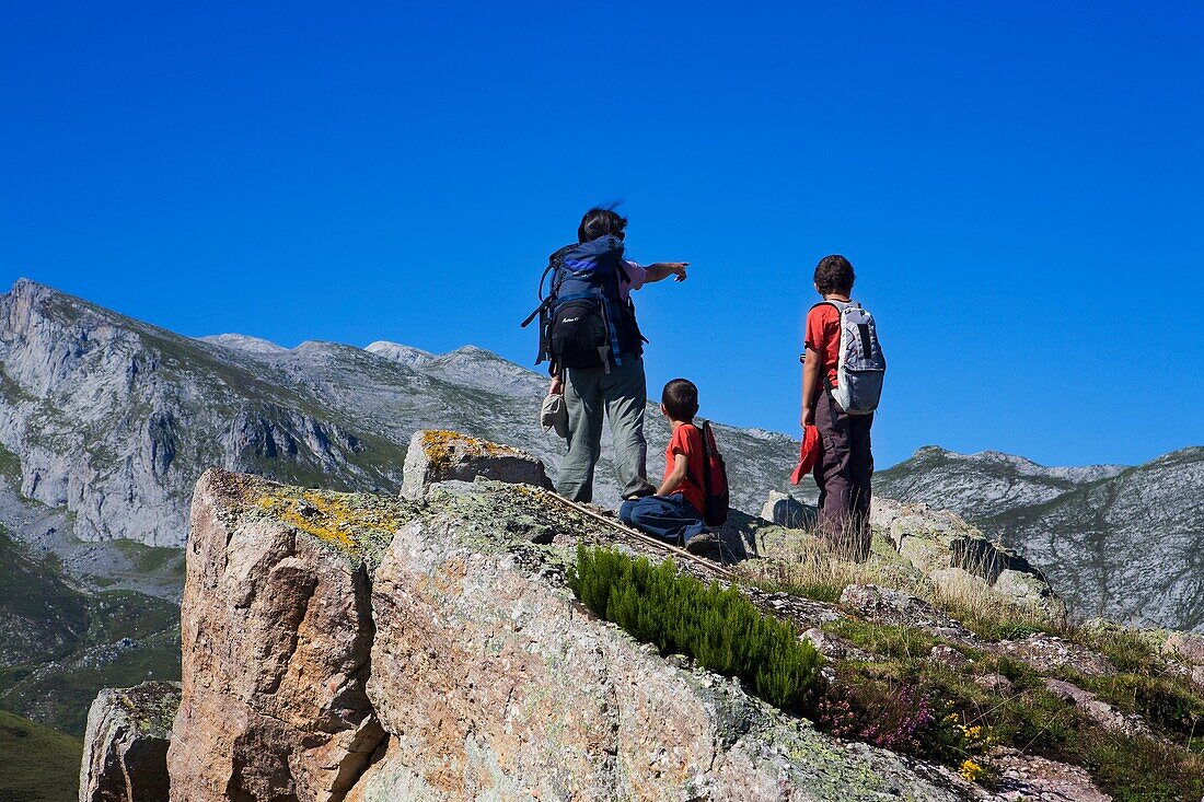 Family of mountaineers in the summit of Cueto Moro in the Ándara massif, Picos de Europa National Park, Bejes in the municipality of Cillorigo de Liébana, in Cantabria, Spain