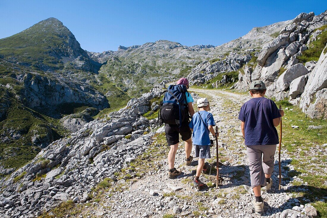 Family practice mountaineering in the Ándara massif, of walking in the Picos de Europa National Park, at bottom the top of La Pica de Mancondiu  Cantabria, Spain