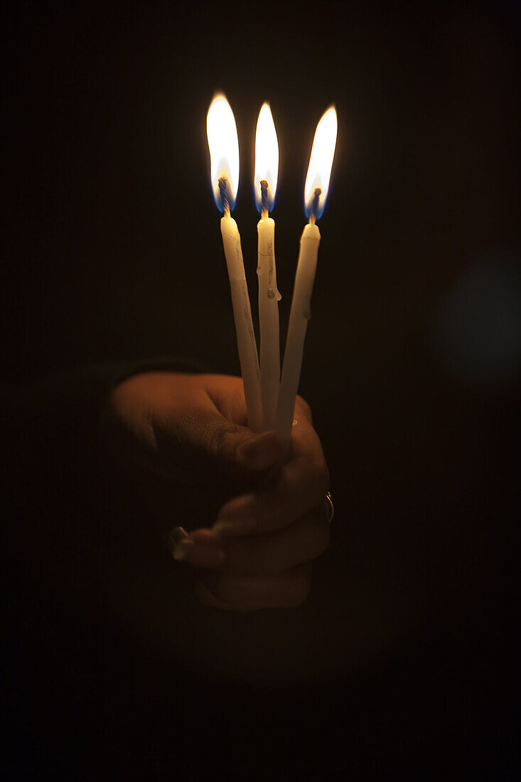 Hand holding candles