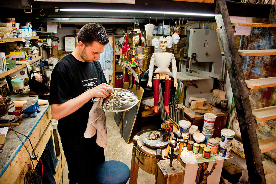 Man building a puppet, Ortigia, Syracuse, Sicily, Italy