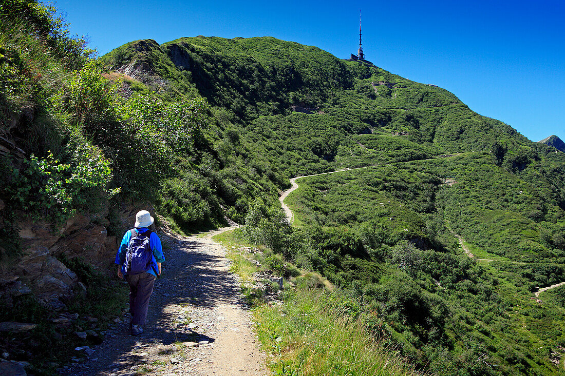 Woman hiking in the mountains to Monte Tamaro, Ticino, Switzerland