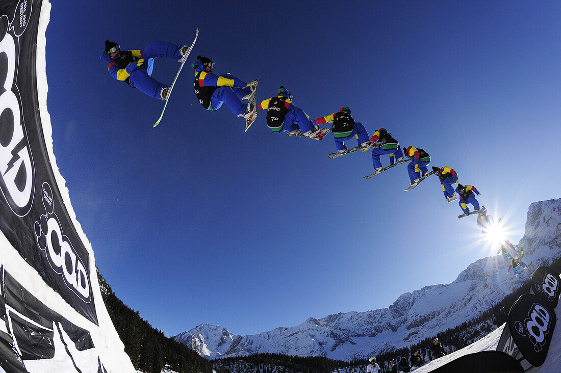 Snowboarder jumping from a kicker, in mid-air, performing a three-sixty, Ehrwalder Alm Funpark, Tiroler Zugspitzarena, Ehrwald, Tyrol, Austria
