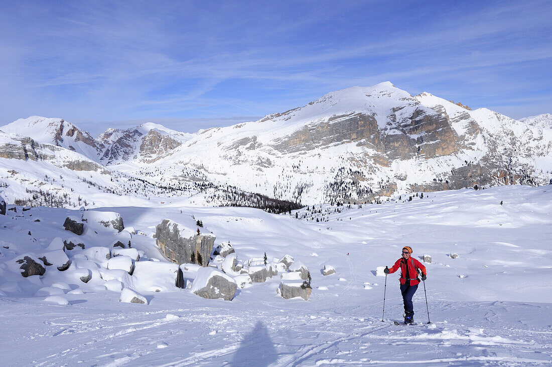 Woman backcountry skiing, ascending, Dolomite summits in the background, Fanes-Sennes natural park, UNESCO World Heritage Site, Dolomites, South Tyrol, Italy