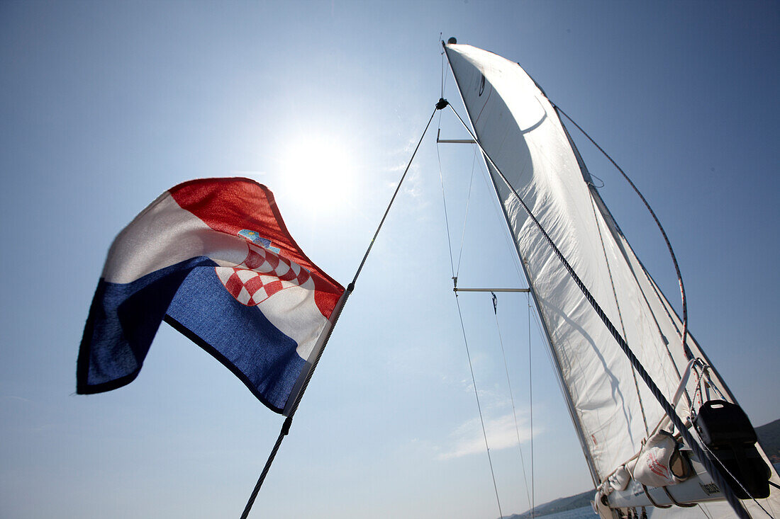 Sailing boat with flag in the sunlight, Croatia, Europe