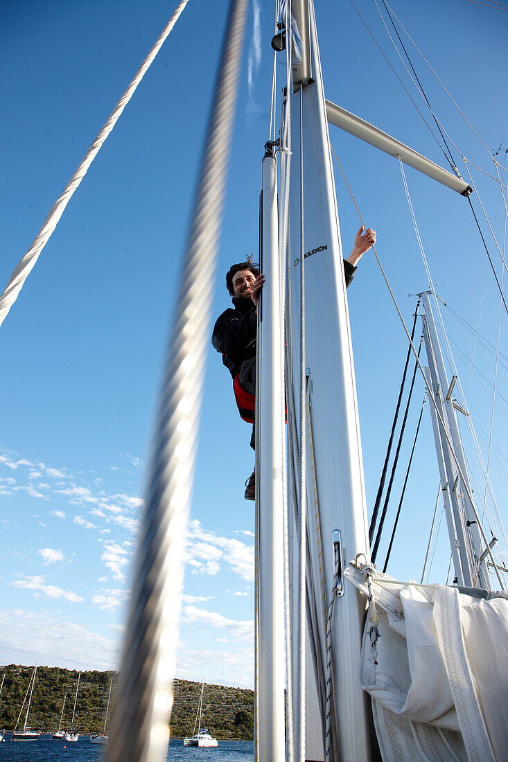 Sailor behind the mast of a sailing boat, Kornati archipelago, Croatia, Europe