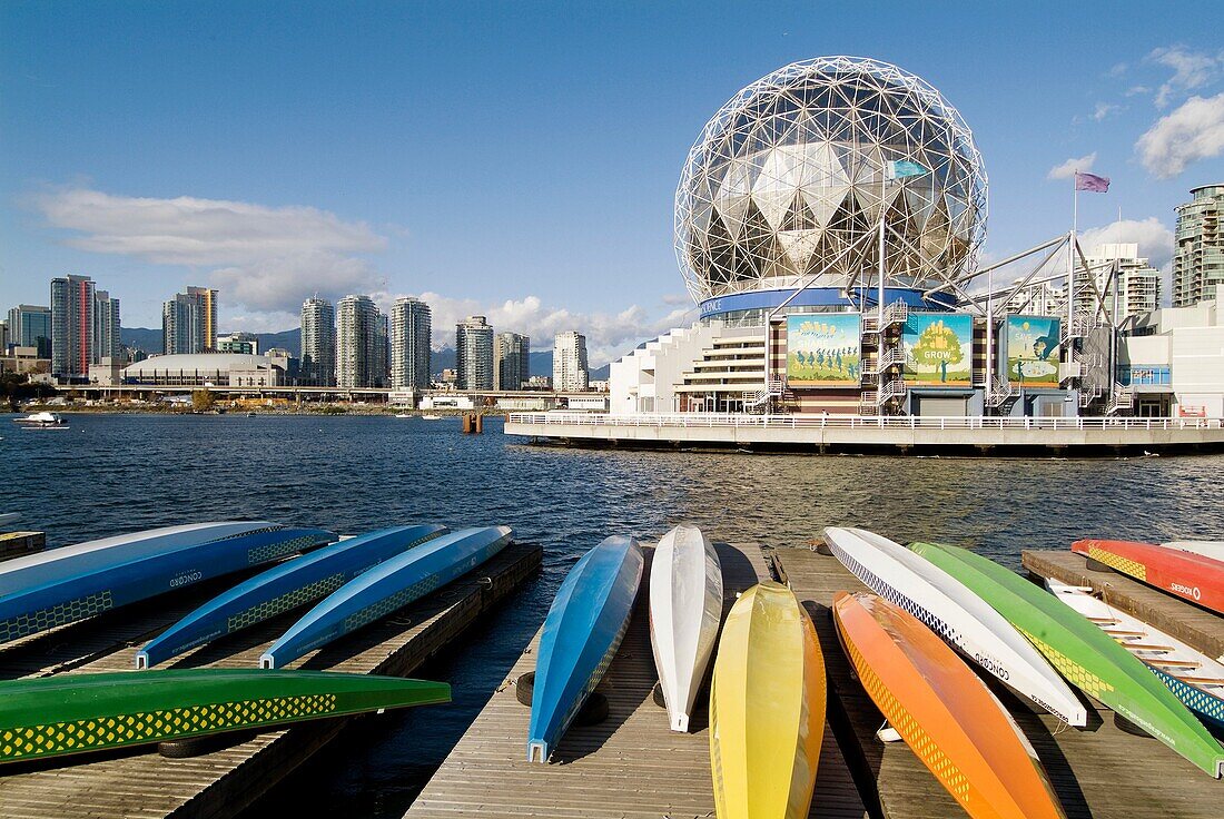 dragonboats in front of Telus World of Science, False Creek, Vancouver, BC, Canada.Downtown Vancouver in background, with GM Place on the left.