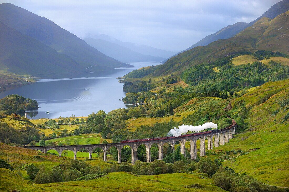 Great Britain, Scotland, The Jacobite Steam Train, better known now as the Harry Potter Train, crossing the viaduct of Glenfinnan with loch Shiel in the background