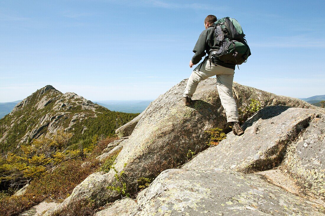 A hiker takes in the view of Mount Chocorua from Middle Sister Trail during the spring months  Located in the White Mountains, New Hampshire USA