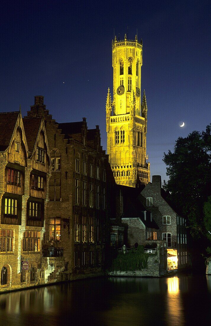 The Belfry tower overlooks canalside houses in the medieval town of Brugge  Belgium