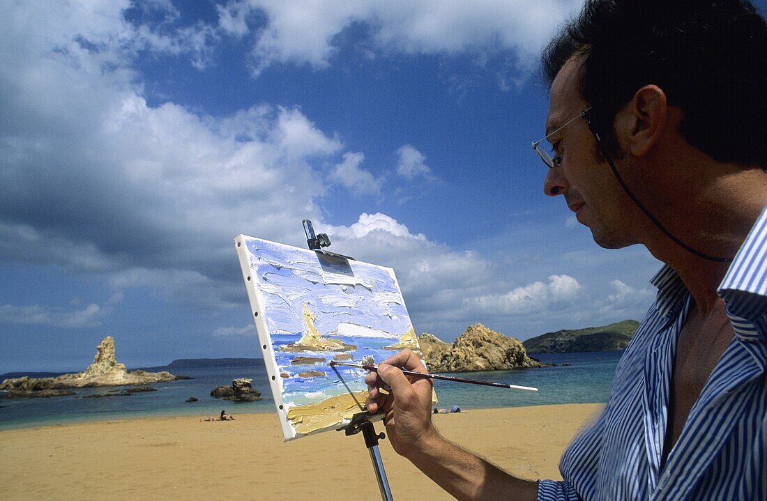 Painter in beach or cala Pregonda  Minorca  Balearis islands  Spain