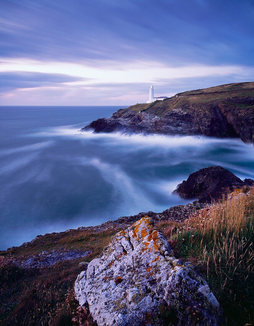 Stinking Cove and the lighthouse at Trevose Head at dusk viewed from Dinas Head on the North Cornwall coast near Padstow, Cornwall, England, United Kingdom