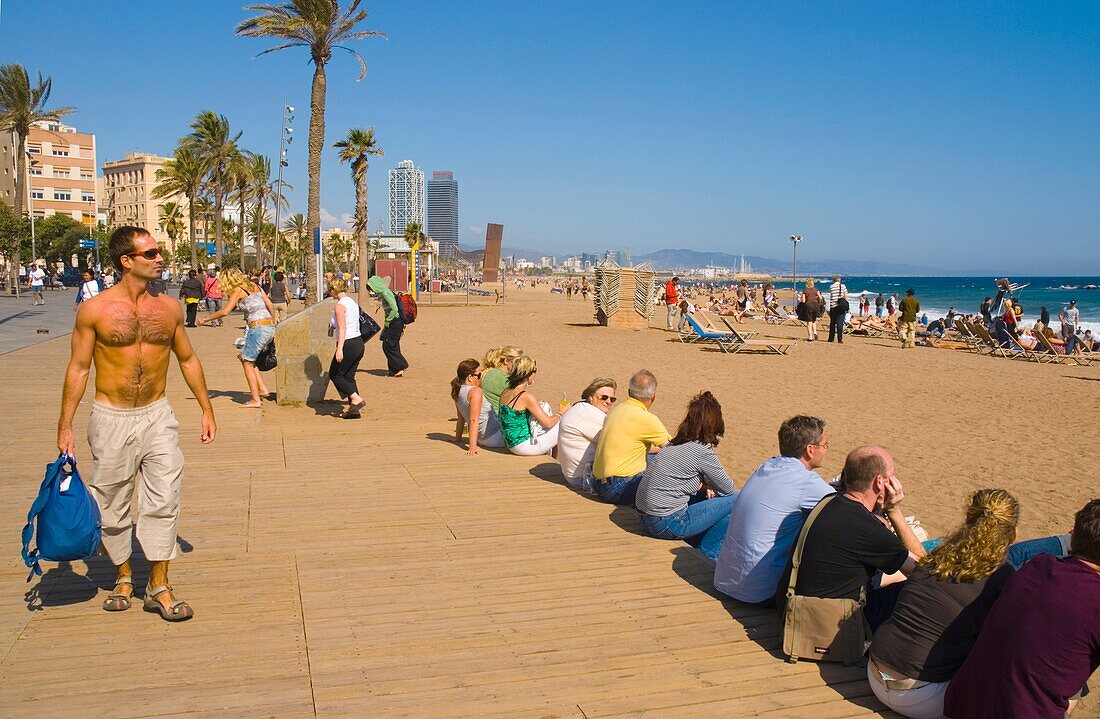 People relaxing at Platja de la Barceloneta beach in Barcelona Spain Europe